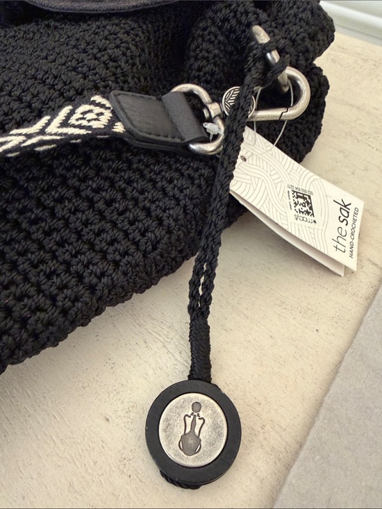 The Sak Black Crochet Convertible Backpack with Tassel and Patterned Strap